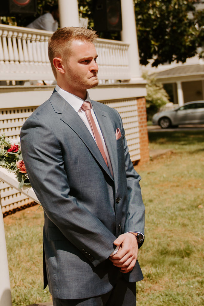 groom's reaction to his bride walking down the aisle photo