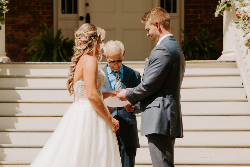 exchanging rings photo uring intimate wedding at the avenel house in Bedford, Virginia