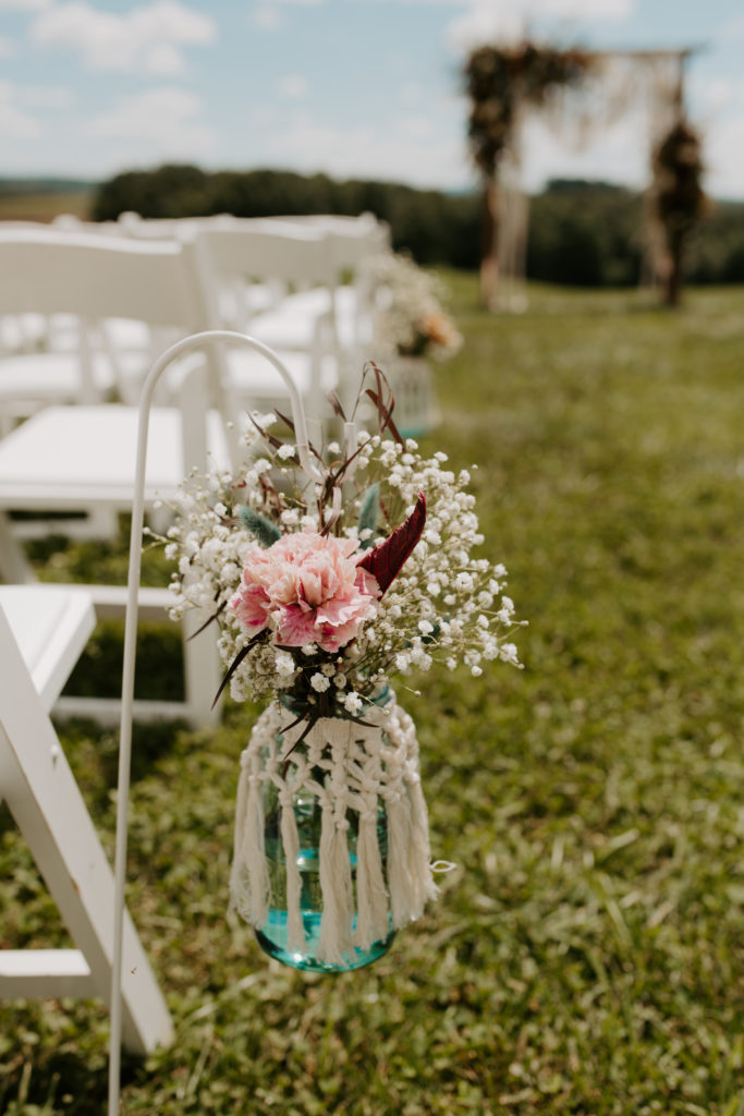 Simple, Virginia backyard wedding ay set up with pink and white florals in mason jars.