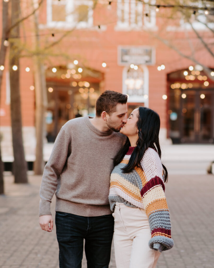 couple kissing in downtown roanoke, virginia during their engagement session