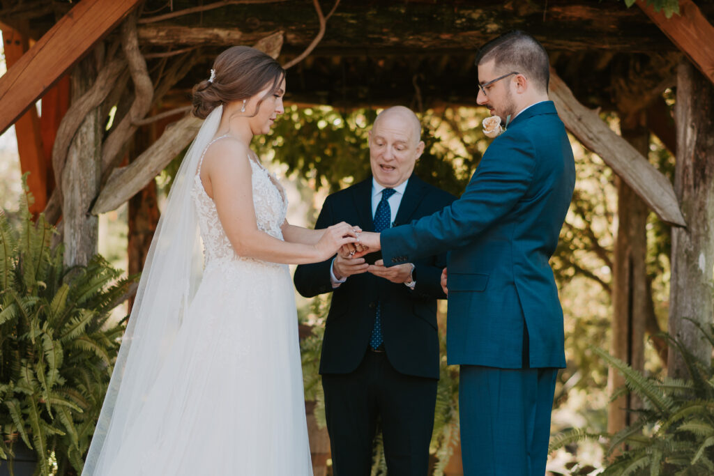 bride and groom exchanging rings during their intimate wedding in virginia shot by kristen noel photography