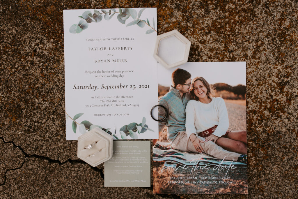 detail wedding photos with the invitation suite, wedding rings, and velvet ring box
