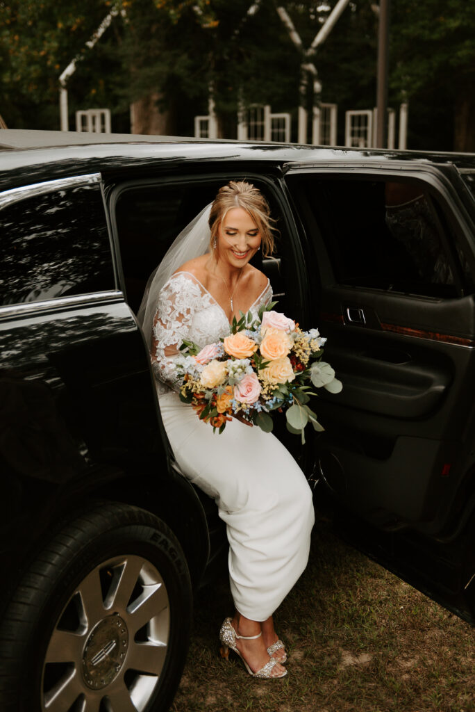 bride getting out of the limousine before walking down the aisle