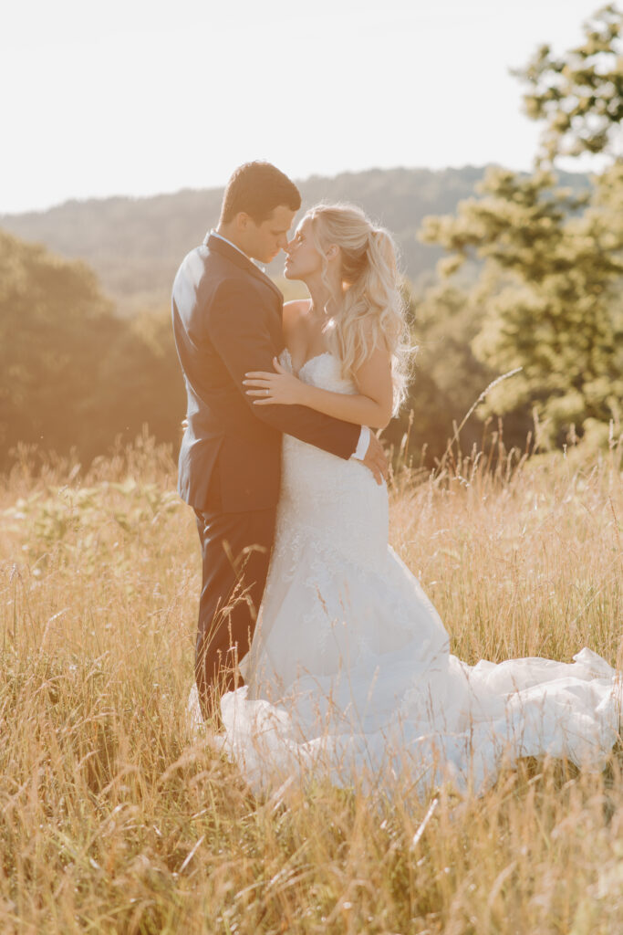 bride and groom slow dancing at sunset in an open meadow field in Shenandoah National Park