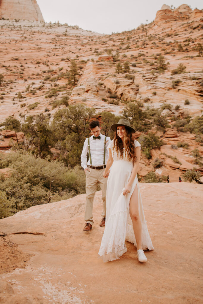 bride leading her groom across the rocks at Zion National Park