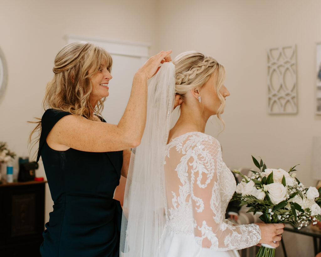 mother of the bride fixing her daughter's veil