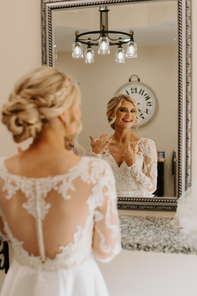 bride admiring herself in the mirror of the bridal suite at Malden Hill Venue in Aylett, Virginia