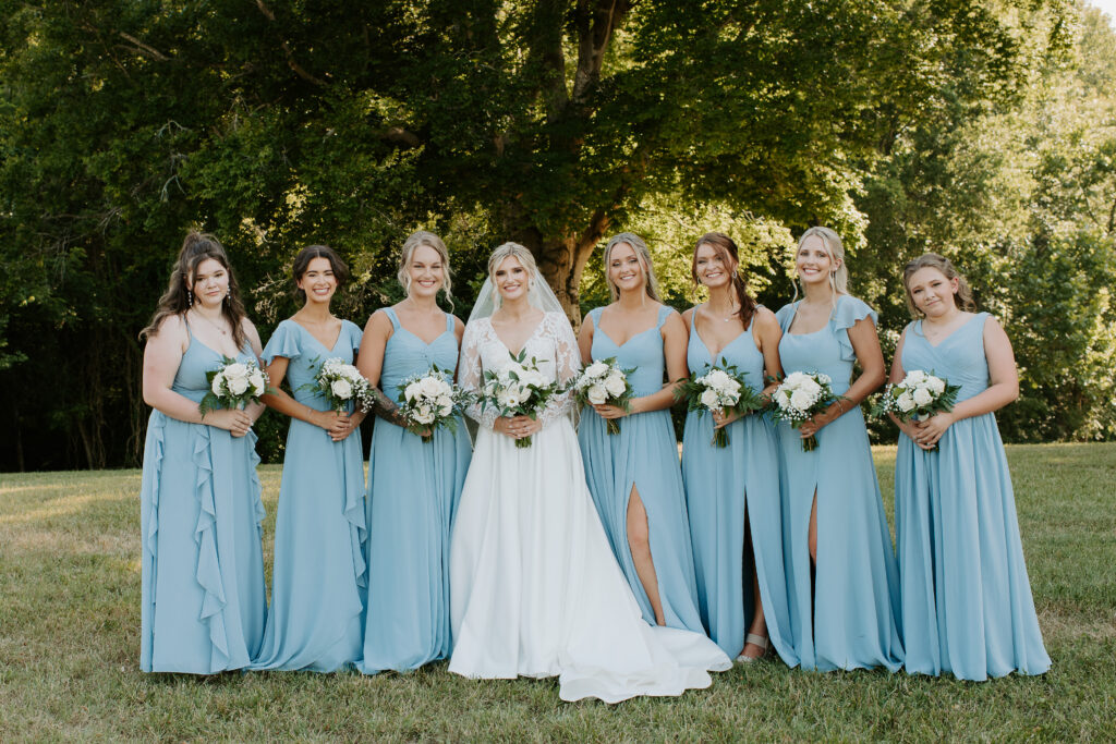 bridesmaids wearing light blue standing beside the bride