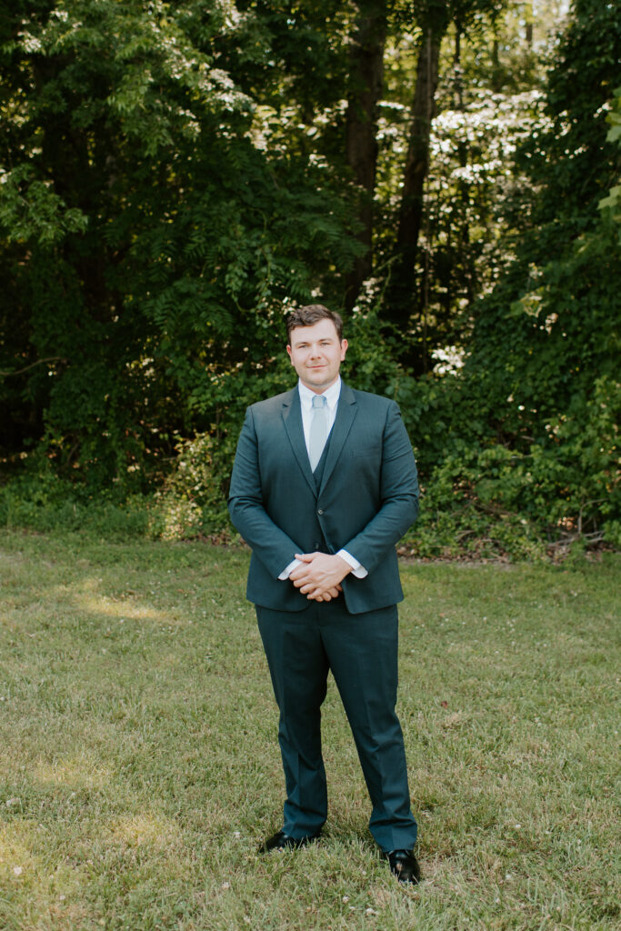 portrait of the groom in a navy suit