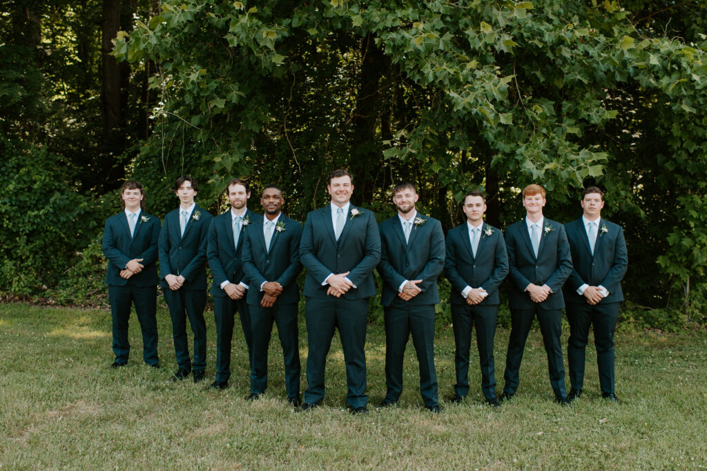 groomsmen wearing navy blue suits