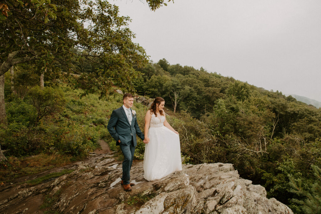 bride and groom looking at the mountains as the fog sets around them