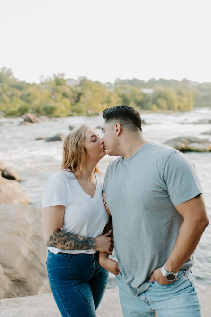 couple kissing on the rocks at Belle Isle, Richmond Virginia
